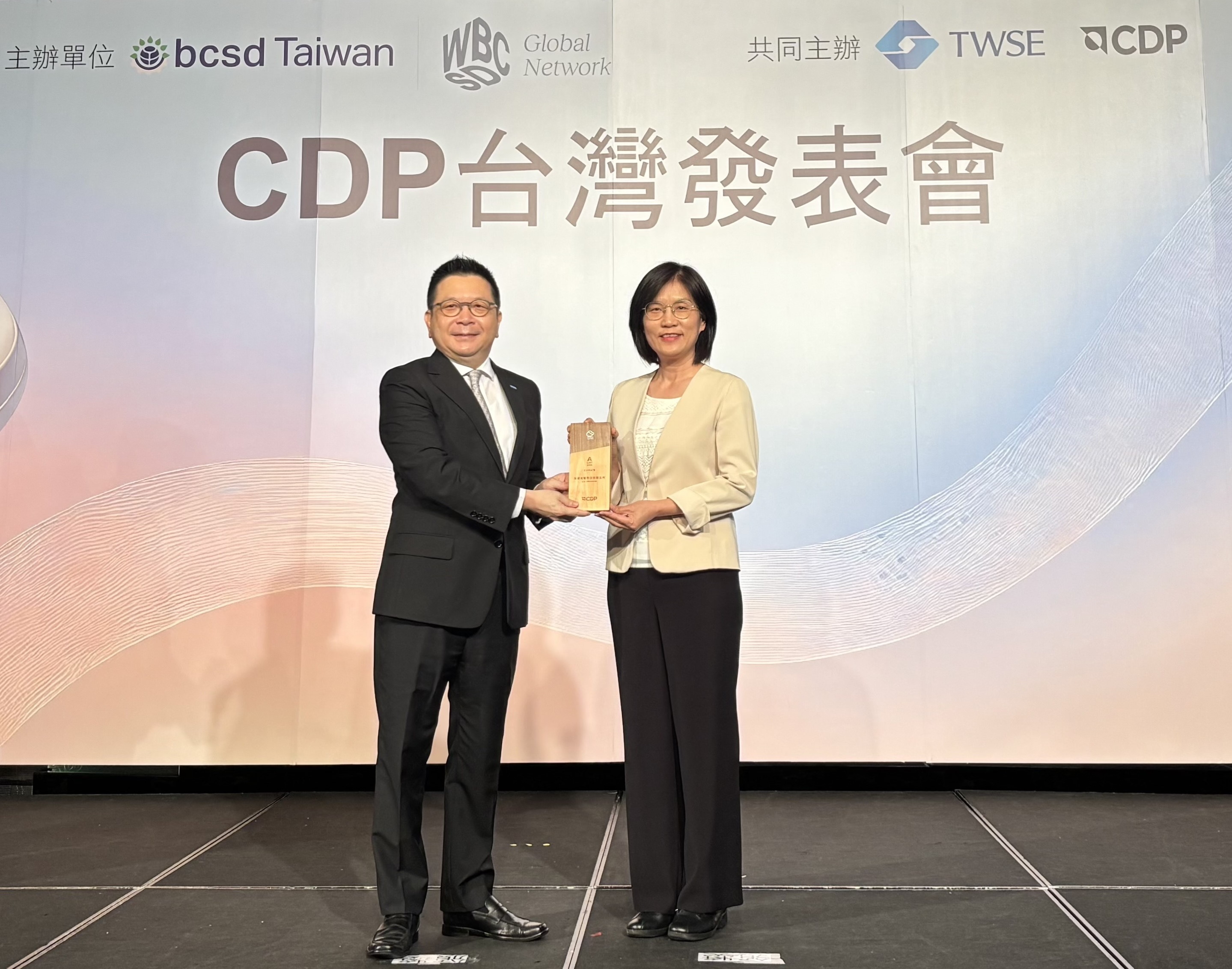 非凡娛樂永續成果再獲國際評比肯定，獲頒CDP氣候與水資源雙項領導力評級。今由臺灣證券交易所董事長林修銘（左）頒獎，非凡娛樂光電永續長古秀華（右）代表受獎